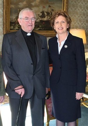 FILE -- This is a Feb. 2008 file photo of the Rev. Aengus Finucane, left, and Ireland's President Mary McAleese. Finucane, a Roman Catholic missionary who braved civil war in Biafra as a pioneer of Irish aid efforts worldwide, died Tuesday, Oct. 6, 2009, his charity announced. He was 77. 'There can be few Irish people of his generation, or of any other generation, who have contributed as much to improving the lives of so much of humanity,' said Tom Arnold, chief executive of the Concern charity that Finucane spent decades promoting.